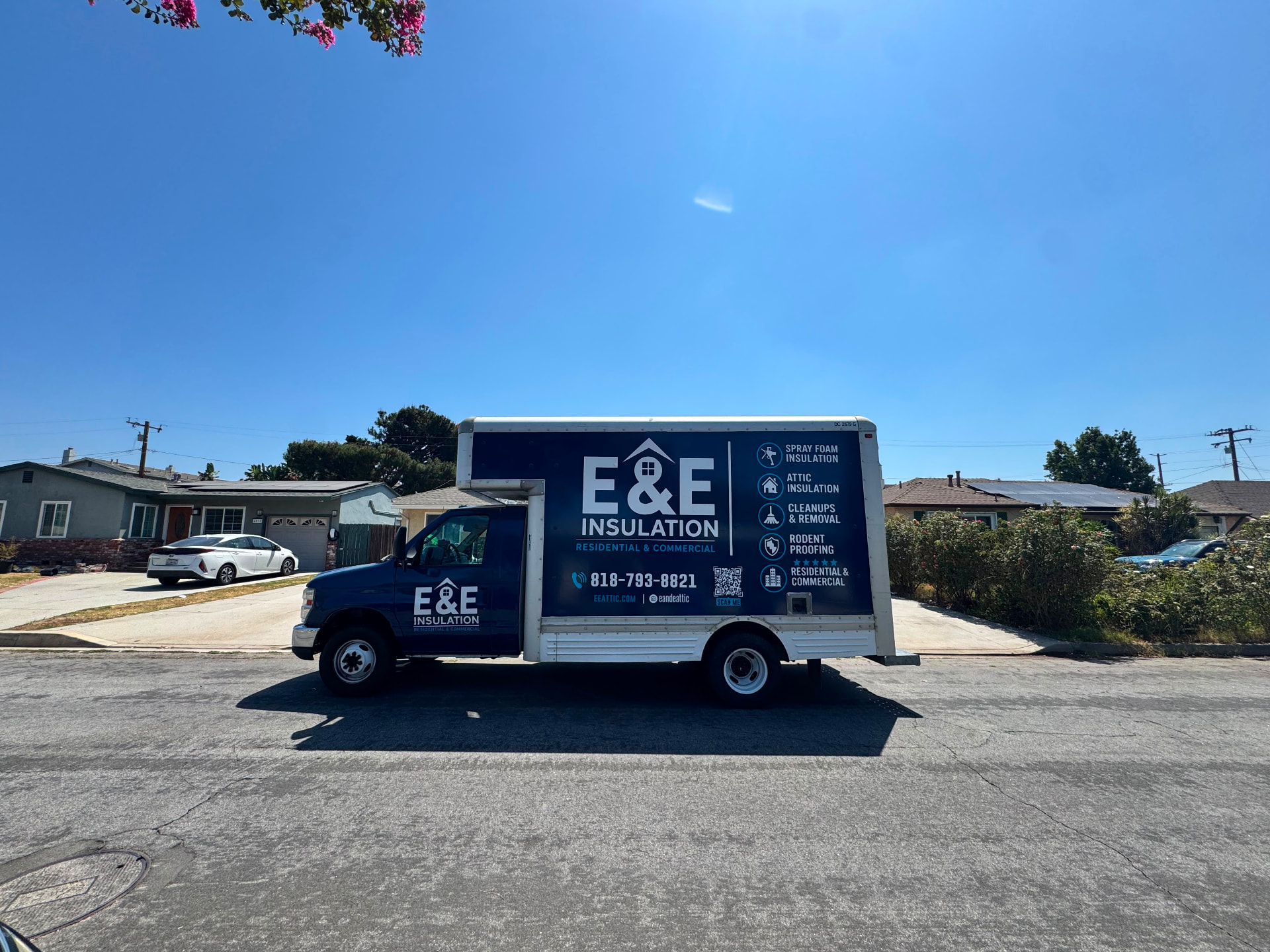 E&E Insulation service truck parked at a job site