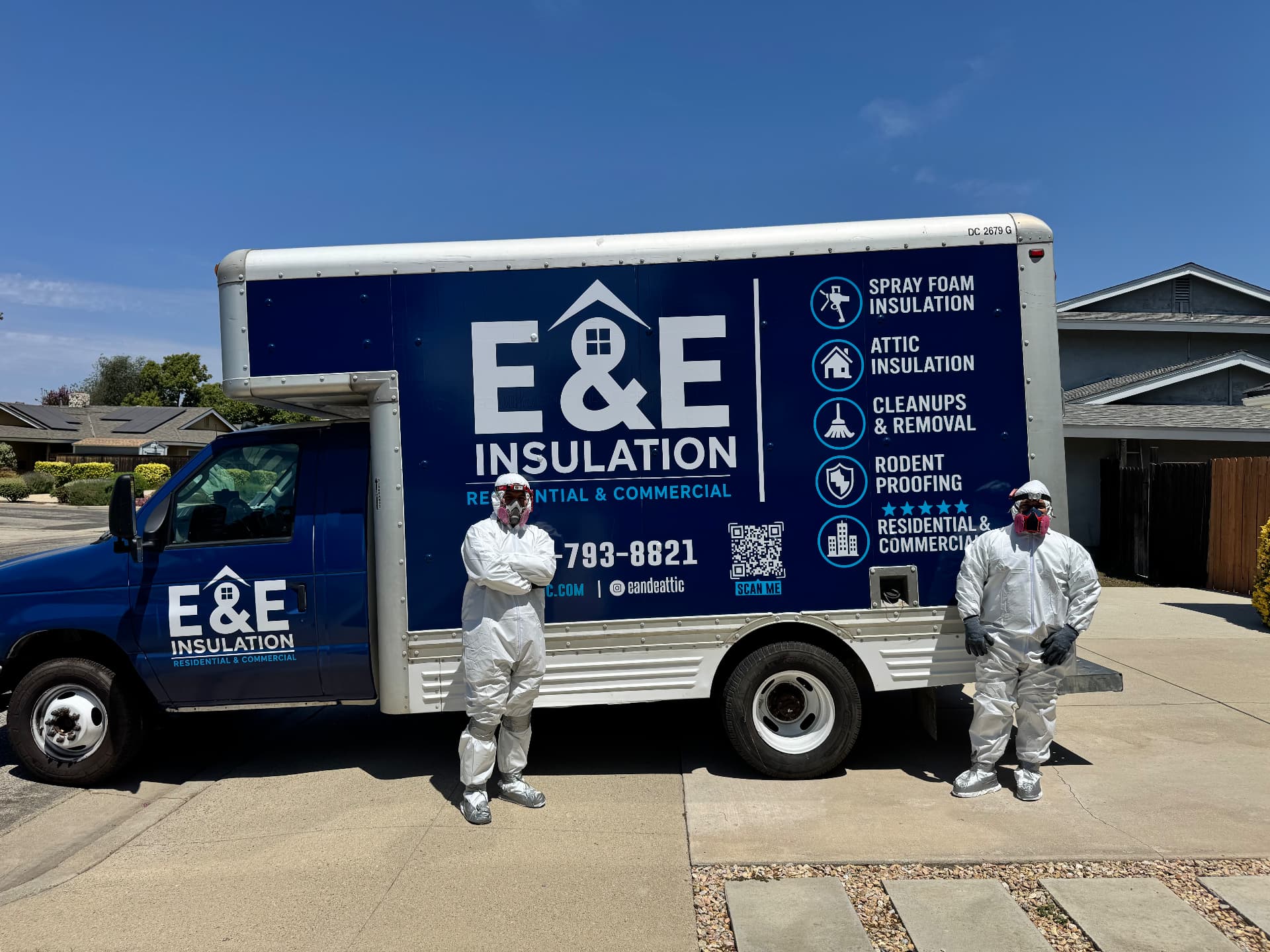 E&E Insulation crew in protective gear beside the company truck